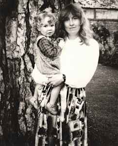 Catherine Guinness holding a Child