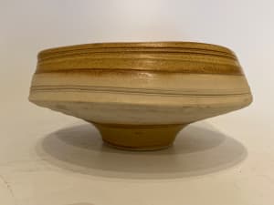 Shallow ceramic ikebana vase on a footed base.