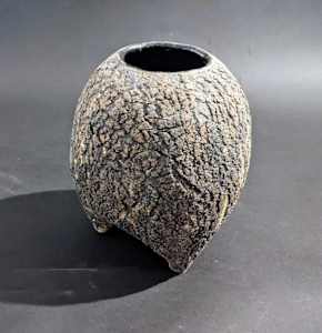 Globular ceramic ikebana vase on three feet