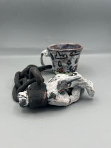 Cup Chained to a Hand
