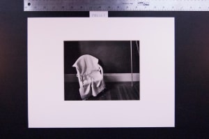 Untitled (wicker chair covered w/ blanket)
