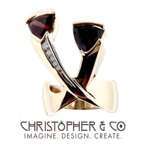 CMJ H 13133    Gold ring set with garnets & diamonds designed by Christopher M. Jupp.