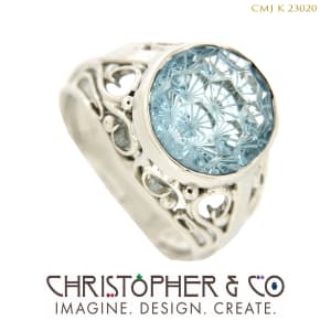 CMJ K 23020  Platinum and Gold ring designed by Christopher M. Jupp set with Brazilian Swiss blue topaz hand cut by Darryl Alexander.