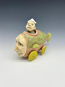 pink and chartreuse fish car with sailor