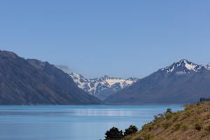 Snowy peaks embracing blue waters