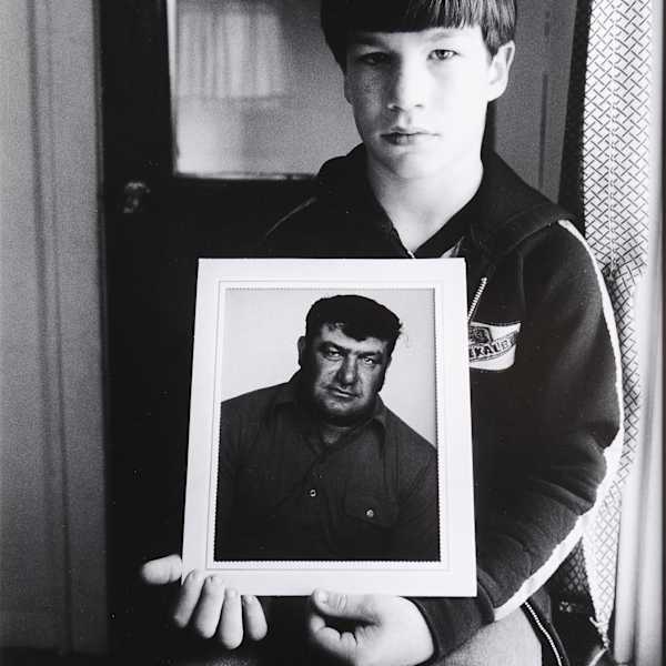 Joseph Fetter (9) of Chelsea Holds a Picture of his Father, Iowa by Stephen Shames, Image 1.