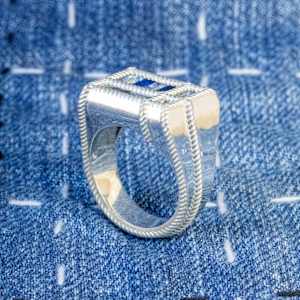 Indigo Blues by Stefano Lonzano  Image: Topaz & Spinel set into Continuum Silver (Palladium, Sterling Silver). Each of the nine thread seam points are individually woven in 3D design software.
