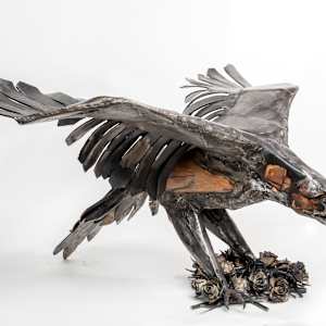 Raptor on Roses by Tolley Marney  Image: Entirely handmade sculpture of forged steel and oakSize: 60” wingspan, 48” long, 28” tall, approx 160 lbs