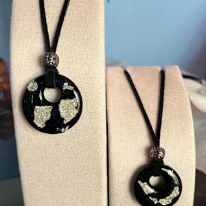 Black opalescent and silver foil pendants by Julie Root Sawyer, Image 1.