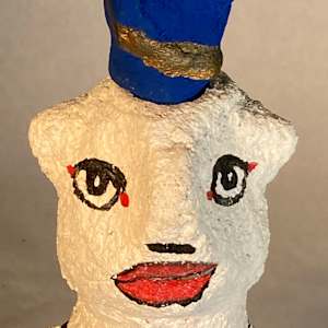 White face with blue and gold hat by Jennifer Taylor