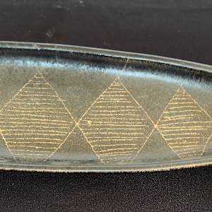 Brown serving tray by . Mann
