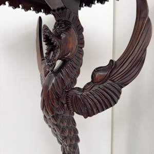 Small table with winged creature 