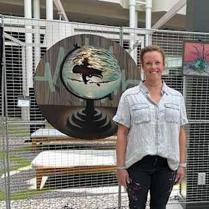 Momentary by Lindsey Veil  Image: Artist with “Momentary” at an exhibition at Northpoint Mall in Alpharetta, GA in May 2025