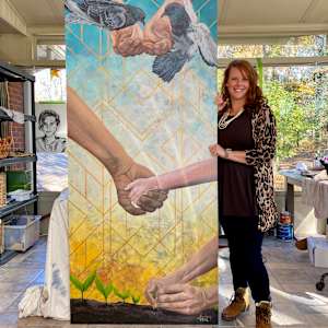 Kindness by Lindsey Veil  Image: Artist next to the painting.