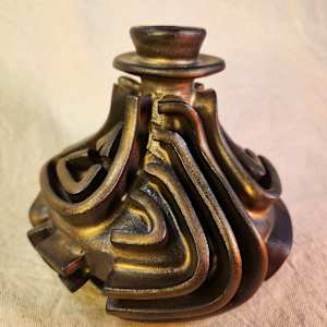 Bronze Assemblage Vase III by Tony Hyden  Image: small modernist sculptural vase glazed in a bronze color with a raised mazelike design