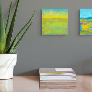 "Landscape #20" by Steven McHugh  Image: Room view of "Landscape #20," a small original abstract landscape by Madeline Island artist Steve McHugh. Featuring bold contrasting yellows and greens and blues, this piece measures 8" x 8" x 2.5" and comes on a wood panel that can be easily hung or placed on a shelf. Each stroke encapsulates the essence of the Apostle Islands, making it a perfect addition to any space seeking a touch of natural elegance. Enjoy the convenience of free shipping within the U.S. when you purchase this exclusive artwork from stevemchughart.com. Transform your environment with this captivating expression of non-representational beauty.

This abstract painting with a horizontal composition that divides the canvas into two distinct sections. The upper part of the painting features a vibrant blend of yellow and turquoise hues, with a textured and cloud-like appearance. The lower section is dominated by a mix of greens and yellows, creating a sense of a landscape or field. The transition between these sections is marked by a thin, darker horizontal line near the center, giving the impression of a horizon. The use of color and texture creates a lively and dynamic visual effect.