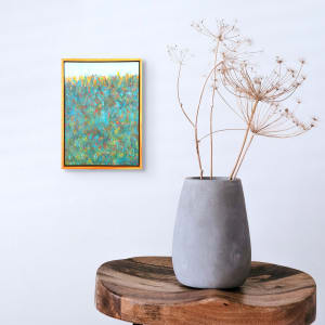 "Color Abstraction #5" by Steven McHugh  Image: Room view of  "Color Abstraction #5" by Steve McHugh, a mixed-media painter from Madeline Island. This original piece captivates with its deep textures and bold contrasting colors dominating the lower two-thirds, seamlessly transitioning into soft pastel blues "Sky". Featuring an intensive teal backdrop accentuated by striking splashes of red, yellow, and blue and punctuated by a horizon line of yellows, this artwork is a visual symphony. The 14.5" x 10.5" x 2.5" wood panel is elegantly framed in a gallery floating frame, making it a standout addition to any art collection. Visit stevemchughart.com to explore this masterpiece and embrace the vibrant, abstract beauty it offers. Sales tax and shipping is calulated when destination is determined.

This  abstract painting with a vibrant and dynamic color composition. The panel is filled with a rich tapestry of colors, predominantly featuring blues and greens, interspersed with bursts of red, yellow, and orange. The brushstrokes are energetic and varied, creating a sense of movement and texture across the painting. The top of the artwork shows a lighter area, giving an impression of depth and suggesting a horizon line. 