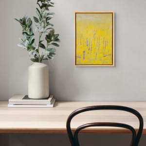 "Revelations" by Steven McHugh  Image: Room view of  "Revelations," a bold abstract landscape painting by Madeline Island artist Steve McHugh. This captivating piece represents a forest with tree trunks in contrasting colors against a luminous yellow background, created with oil and cold wax on a wood panel measuring 14.25" x 10.5" x 2.5". Framed in a natural wood gallery floating frame, it adds an elegant touch to any space. Steve's unique style and deep connection to the Apostle Islands are infused in every brushstroke, offering both visual pleasure and profound inspiration. Elevate your collection with this stand-out work from a renowned mixed-media non-representational abstract painter.

The artwork is a painting primarily featuring vertical lines representing  trees. The color palette predominantly consists of vibrant yellows, lending a bright and warm tone to the piece. Additional colors like hints of purple, blue, and red intersperse the yellow, creating a sense of depth and texture. The background is a muted yellow-green, evoking a serene atmosphere. The painting is enclosed in a simple wooden frame that complements the natural theme of the artwork. The overall impression is abstract, with the shapes and colors blending together to create a lively yet harmonious composition.

Shipping and sales tax added after destination is determined.