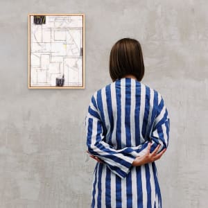 "This Space In Time" by Steven McHugh  Image: Room view of "This Space In Time," a stunning work by Steve McHugh that redefines minimalism. What first appears to be just a minimalist, abstract painting in white holds layers of textures, modern composition in crayon and pencil, bold strokes and mark making and subtle colors. This study for urban setting is crafted using oil, cold wax, crayon, and graphite on wood panel covered with layers of canvas. Measuring 16.75" x 12.75" x 2.5", it is a testament to the intricate and purposeful layering that characterizes McHugh's work newest collection. Ideal for discerning collectors, this piece captures the essence of modern abstraction with a refined touch.

This minimalist, abstract painting  features a series of thin, intersecting lines creating a geometric composition. The primary colors used are black, yellow, and shades of gray on a predominantly white background. The lines and shapes form various rectangular and polygonal forms, some filled with color and texture, creating a sense of depth and movement within the composition. The overall style is modern and abstract, with a focus on linear structures and subtle color contrasts. Framed in a simple wood gallery floating frame.

Sales tax and shipping costs determined with destination.