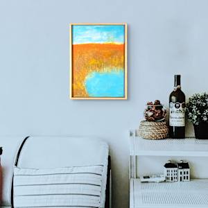 "Grassland #2" by Steven McHugh  Image: Room view of Immerse  of "Grassland #2," a striking piece that captures the essence of natural landscapes through mixed-media techniques. As an abstract painter based on Madeline Island in the serene Apostle Islands of Lake Superior, WI, I explore the interplay of texture, color, and form in every creation. "Grassland #2" reflects my commitment to non-representational artistry, inviting viewers to engage with the work on a deeply personal level.

This artwork is a landscape painting featuring a serene natural scene, a pond among the tall grasses. The upper portion of the painting showcases a soft blue sky with subtle variations of white and light yellow, suggesting a calm day with scattered clouds. Below the sky, an expanse of warm earthy tones dominates the middle ground, using ochre, burnt sienna, and muted brown hues to depict a dense field or hillside. The lower part of the composition includes a bright, reflective blue body of water that contrasts vividly with the surrounding warm colors. The brushstrokes in the painting are textured and impressionistic, conveying the forms of natural elements like grass and water with a loose, expressive style. The overall mood of the artwork is tranquil and evocative of an autumnal landscape.

Original mixed media abstract oil painting by Steven McHugh. Mixed media with oil stick, marker, oil, graphite, charcoal and cold wax on Arches oil paper glued on wood panel with PH balance glue. Painting is 13.5"x 9.75" x 1.5". Signed on front and back. Framed is a vanished gallery frame solid wood. 