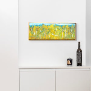 "Old Path" by Steven McHugh  Image: Interior installation view of "Old Path," a mixed-media oil and cold-wax painting that encapsulates the raw beauty of Madeline Island, set amidst the Apostle Islands in Lake Superior, WI.  My abstract pieces like "Old Path" invite you to explore the endless possibilities of color and texture. Embrace the emotion and energy that radiate from this unique artwork, a testament to the rugged and serene landscapes that inspire my creative spirit. Ideal for art enthusiasts who appreciate depth, movement, and the unexpected, "Old Path" is more than a painting—it's an experience. 

"Old Path" is a landscape painting depicting a dense grove of birch trees with white trunks and branches interspersed among vibrant yellow and green foliage. The birch trunks stand upright against a backdrop of lush vegetation dominated by rich yellows, with touches of green throughout. The painting conveys a sense of depth and natural serenity with a textured, almost impressionistic style that blends the colors to create the effect of dappled light filtering through the leaves. The composition extends horizontally, emphasizing the expansive nature of the forest scene.

Painting measures 10" x 29.25" x 1.5" and in a gallery floating frame measuring 10.75" x 30.25" x 2.5" and shipping is included in this price to anywhere in the lower 48 U.S. states.