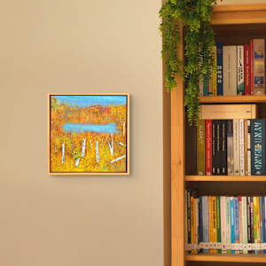 "Out There" by Steven McHugh  Image: Explore the vibrant and captivating world of mixed-media  abstract art, crafted with passion on Madeline Island in the stunning Apostle Islands of Lake Superior, WI. Each piece is a unique journey of color, texture, and form, embodying the raw beauty and untamed spirit of the island. "Let my creations infuse your space with energy and emotion, inviting you to find your own meaning in the abstract."  Discover out there the essence of creativity and elevate your environment with art that speaks beyond words.

Interior installation view of "Out There," a vibrant autumn landscape with a dense forest of birch trees characterized by their distinctive white bark. The foliage consists of warm shades of yellow, orange, and red, creating a rich tapestry of fall colors. In the middle of the composition, a calm, reflective blue lake contrasts with the earthy tones surrounding it. The sky above is a soft blue with wispy hints of clouds, adding a tranquil atmosphere to the scene. The brushwork and texture convey a sense of depth and the natural beauty of the season, capturing the essence of a serene autumn day. 

This oil and cold-wax painting on wood panel is framed in a gallery floating frame and measures 13" x 13" x 2.5".  Shipping is included in the U.S.
