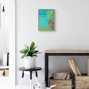"Jumping Spot" by Steven McHugh  Image: Interior view of"Jumping Spot," a vibrant, mixed-media representational abstract painting that captures the essence of freedom and spontaneity. Created by a passionate artist nestled in the serene embrace of Madeline Island, part of the Apostle Islands in Lake Superior, WI, this artwork delivers a dynamic dance of colors and textures. Experience the exhilaration of art designed to uplift and inspire your space. Dive into the world of stevemchugh.art and find unique pieces that resonate with your soul. Visit today and let your walls speak volumes with distinctive, enthusiastic artistry.

This 16.25" x 12.25" x 2.5" oil and cold wax painting on wood panel includes shipping in the U.S.

 "Jumping Spot" presents a serene lakeside scene where a rocky outcrop juts out into vibrant blue water. The rocks are depicted with warm earthy tones, primarily shades of brown and orange, giving them a textured and layered appearance. Above the rocks, a cluster of lush green trees, rendered with dabs of bright and varied green hues, stand tall and lively. The background features a distant landmass in muted tones, contrasting with the vivid foreground. The water is painted with sweeping horizontal strokes in multiple shades of blue and green, giving it a sense of depth and gentle movement. The overall composition conveys a tranquil and natural setting bathed in soft light.