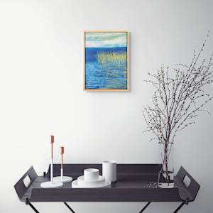 "Where Food Grows on Water" by Steven McHugh  Image: Interior view of "Where Food Grows on Water," a striking abstract piece by mixed-media artist Steve McHugh. Inspired by the unique environment of Madeline Island, part of the Apostle Islands in Lake Superior, WI, this artwork fuses vibrant colors and dynamic textures, embodying the harmony of nature. Each layer invites the viewer to explore the delicate balance where land and water intertwine, reflecting the artist’s profound connection to his surroundings. Perfect for art enthusiasts seeking to bring a touch of natural elegance to their space, this piece showcases Steve McHugh’s dedication to capturing the essence of his island home through his painting. Discover how "Where Food Grows on Water" can transform your environment at stevemchugh.art.

"Where Food Grows On Water" depicts a tranquil water scene with tall wild rice at the water's edge. The palette includes rich blues and greens, creating a serene and calm atmosphere. The brushstrokes are textured and layered, emphasizing the natural movement and reflection on the water’s surface. The sky above is depicted with soft, blended hues of light blue and white, adding depth to the composition. The overall effect conveys a peaceful, natural landscape focused on water and life. This oil and cold-wax painting measures 16.25" x 12.25" x 2.5" and is framed in a gallery floating frame.