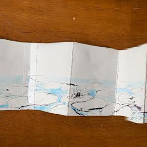 Resilience (Concertina) by Jackie Begue  Image: Unfolded back design is a black and white pen sketch of a lily pad pond.
