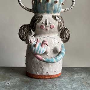 woman holding baby vase by Alyssa Martz