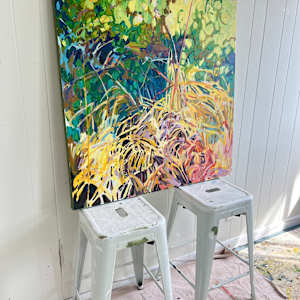 Microcosm by Krista Townsend  Image: The painting on two stools leaning against the studio wall pictured at an angle.
