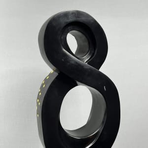 Lucky 8 by Scott Gentry Sculpture  Image: Scott Gentry Sculpture. "Lucky 8" rear view. Atlantic black marble with gold leaf on black granite base. Measures 31.5H x 13.5W x 12D inches.
