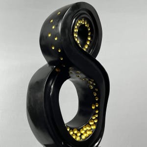 Lucky 8 by Scott Gentry Sculpture  Image: Scott Gentry Sculpture. "Lucky 8" left front view. Atlantic black marble with gold leaf on black granite base. Measures 31.5H x 13.5W x 12D inches.