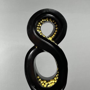 Lucky 8 by Scott Gentry Sculpture  Image: Scott Gentry Sculpture. "Lucky 8" front view. Atlantic black marble with gold leaf on black granite base. Measures 31.5H x 13.5W x 12D inches.