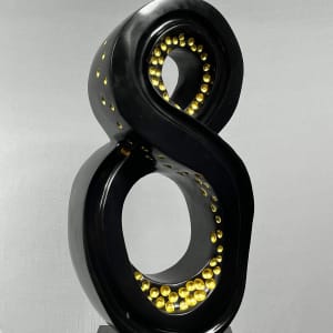 Lucky 8 by Scott Gentry Sculpture  Image: Scott Gentry Sculpture. "Lucky 8" left front view. Atlantic black marble with gold leaf on black granite base. Measures 31.5H x 13.5W x 12D inches.