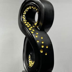 Lucky 8 by Scott Gentry Sculpture  Image: Scott Gentry Sculpture. "Lucky 8" right front view. Atlantic black marble with gold leaf on black granite base. Measures 31.5H x 13.5W x 12D inches.