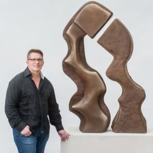 Us 3/10 by Scott Gentry Sculpture  Image: Scott Gentry, sculptor, with "Us #1 of 10" bronze sculpture (size comparison)