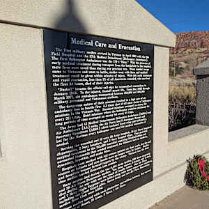 Cedar City War Memorial - Vietnam War by James Muir  Image: Photograph by Jacob B. Arnell. Licensed by Creative Commons (CC BY-SA).
Medical Care and Evacuation

The first military medics arrived in Vietnam in April 1962 with the 8th Field Hospital and the 57th Medical Detachment (Helicopter Ambulance). The first Helicopter Ambulance was the UH-1 "Huey." With the presence of early medical treatment during transport from the battlefield to the hospital, more lives were saved than during any previous war. When combat troops came to Vietnam and went to battle, medics went with them and medical treatment could be given within minutes of injury. With this early treatment and rapid evacuation, less than 1% of all Americans wounded, who survived the first 24 hours, died of their injuries.

“Dustoff” became the official call sign for aeromedical evacuations in January 1964. To the injured, Dustoff meant life. From May 1962 through March 1973, air ambulances transported between 850,000 and 900,000 military personnel and Vietnamese civilians.

The dangerous nature of their missions resulted in a high rate of air ambulance loss to hostile fire: 3.3 times that of other types of helicopter missions in the Vietnam War. Standard missions averaged an enemy attack every 311 trips. Hoist missions where the helicopter remained stationary for long periods of time averaged an enemy hit every 4.5 trips.

The Army had 13 Medical Detachments Helicopter Ambulance and 3 Air Ambulance (AA) units. The Air Force had 4 Aerospace Rescue and Recovery Squadrons (ARRS) which included fixed-wing medical evacuation but for the Marines every helicopter was used for medical evacuation if needed.

Serving the wounded and ill were 25 Army hospitals, 10 Air Force hospitals, 2 Navy hospitals, and 2 Navy hospital ships that provided dispensaries. Among the 155,362 wounded requiring hospitalization, 96% returned to the US. The remaining 4% were treated for illnesses such as malaria, uncontrolled hepatitis, and snake bites.

Hospitals were marked with red crosses painted on their roofs, but the red crosses sometimes became targets by the enemy. When medics with red crosses on their helmets arrived with troops on the battlefield, the medics and hospitals became favored targets by the enemy. (96% of wounded and medics cite firearms, not land mines as weapons that wounded them.)

Many medics died performing their duties. 401 Army medics, 48 Navy Corpsmen, and 7 Air Force Pararescue were killed. Many others were seriously wounded during their war duties. The selfless actions of medics, corpsmen, and Air Force Pararescue personnel saved many lives and are credited with reducing combat deaths in Vietnam by 25%.

US medics killed in action include 401 Army, 48 Navy Corpsmen, and 7 Air Force Pararescue.

Some medics served with such distinction and selfless bravery, they earned the Medal of Honor, 15 Army, 3 Navy, 1 Air Force.