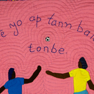 Playing Soccer - Jwé yo ap tann balon-an tonbe by Delicia 