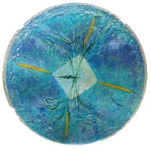 "The Beach" by Nancy Gong  Image: "At the Beach"  Detail
Fused and kiln formed glass with vitreous paint and copper leaf. Shown in a stand with option for  handing off the wall.