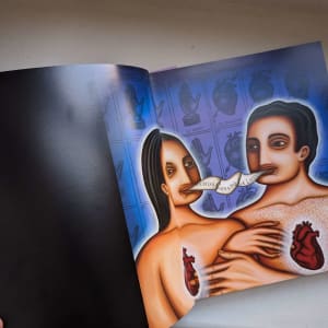 La Loteria: An Exploration of Mexico an installation of 54 paintings by Teresa Villegas  Image: Opening pages of this book show the painting on a double page spread with the credits to the artist Teresa Villegas on the bottom of the left page.