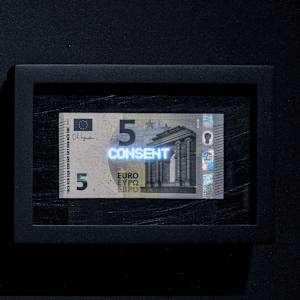 Planetary Values- 5 Euro Bill - Consent by Jorge Luis Vaca Forero  Image: Planetary Values- 5  Euro Bill / (Consent) is a unique approach to global politics. It focuses on the Euro bill, one of the main currencies in the world economy. This project highlights the most frequently mentioned values from the European Union’s Constitution by using laser cuttings to create perforations in the bills, which are then illuminated by LED lights.

The aim is to challenge the legitimacy and symbolic significance of the State. It does this by connecting the symbolism of money with the economy it represents and the values and commitments made by governments that are often not met around the world. The words on the bills can only be seen when illuminated, emphasizing their hidden nature.

This initiative turns these bills into seemingly useless objects and invites us to reconsider the global significance of currency. It questions the ideals of peace, well-being, and democracy that nations claim to uphold for their citizens, suggesting that these ideals may not be fully realized and are limited by the currency that represents economic and social exchanges.

