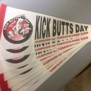"Kick Butts Day" -- Pennant by Garry Trudeau
