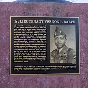 Buffalo Solider by Chris Navarro  Image: A bronze plaque mounted on the sculpture base that says:
 " 1st LIEUTENANT VERNON J. BAKER
Born in Cheyenne, Wyoming, on December 17, 1919 Vernon Baker would become the last of online World War II African Americans to win the Congressional Medal of Honor. Commissioned as a 2nd Lieutenant after completing Officer Candidate School, Baker served in an all black company that was part of the 370th Infantry Regiment, 92nd Infantry. On April 5-6, 1945, near Castle Aghinolfi in northern Italy, Baker, with the assistance of his men, showed extraordinary heroism by destroying two enemy positions. He then covered the evacuation of his company's wounded by drawing enemy fire to his exposed position. The following night, he voluntarily led a battalion-sized assault against the enemy through minefields and heavy fire. In the end, Baker and his unit would kill 26 Germans, destroy 6 machine gun nests, 2 observation posts, and 4 dugouts in this predawn battle. Baker earned a Purple Heart, a Bronze Star, and the Distinguished Service Cross while becoming one of the most highly decorated African American soldiers serving in the Mediterranean Theater.
Army Magazine
On January 13, 1997, 52 years after his World War II military service, President Bill Clinton presented Vernon Baker with the Medal of Honor, the Nation's highest decoration for battlefield valor. Baker was literally the last WWII Buffalo Soldier to be so recognized."