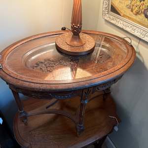 carved oval glass top table with removable tray 