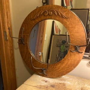 Turn of the century round oak mirror with hooks 