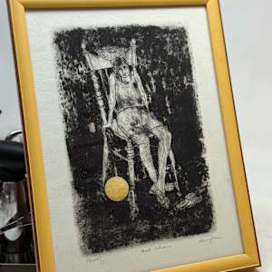 Framed etching of girl in chair 