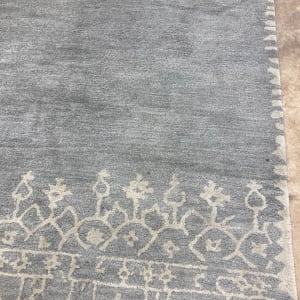 Grey machine made rug 