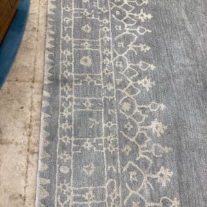 Grey machine made rug 