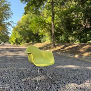 Yellow Herman Miller shell arm chair